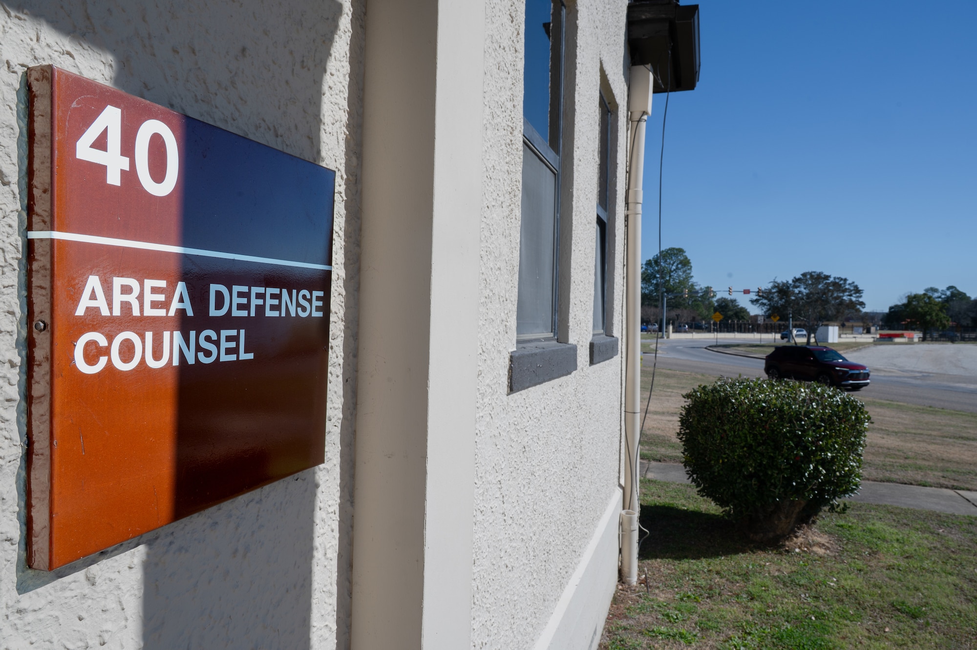 The Area Defense Counsel sign hangs on the outside of a building at Maxwell Air Force Base, Alabama, Feb. 12, 2026. By providing confidential legal counsel, the Area Defense Counsel helps Airmen navigate complex situations while maintaining focus on their duties, supporting overall readiness across the wing. (U.S. Air Force photo by Senior Airman Mikayla Cardona)