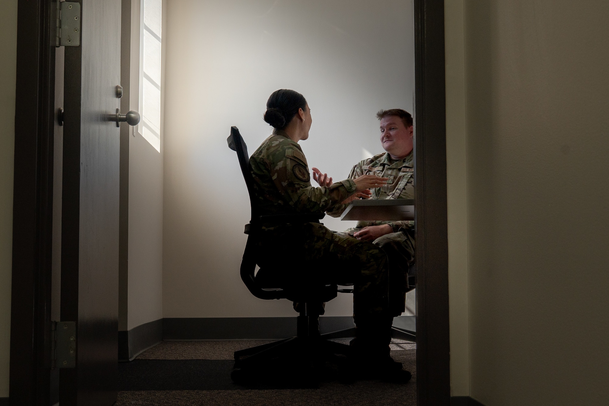 U.S. Air Force Staff Sgt. Quest Largent, Maxwell Area Defense Counsel defense paralegal, talks to Maj. Rachel Sistrunk, Maxwell ADC area defense counsel, at Maxwell Air Force Base, Alabama, Feb. 12, 2026. By providing confidential legal counsel, the Area Defense Counsel helps Airmen navigate complex situations while maintaining focus on their duties, supporting overall readiness across the wing. (U.S. Air Force photo by Senior Airman Mikayla Cardona)