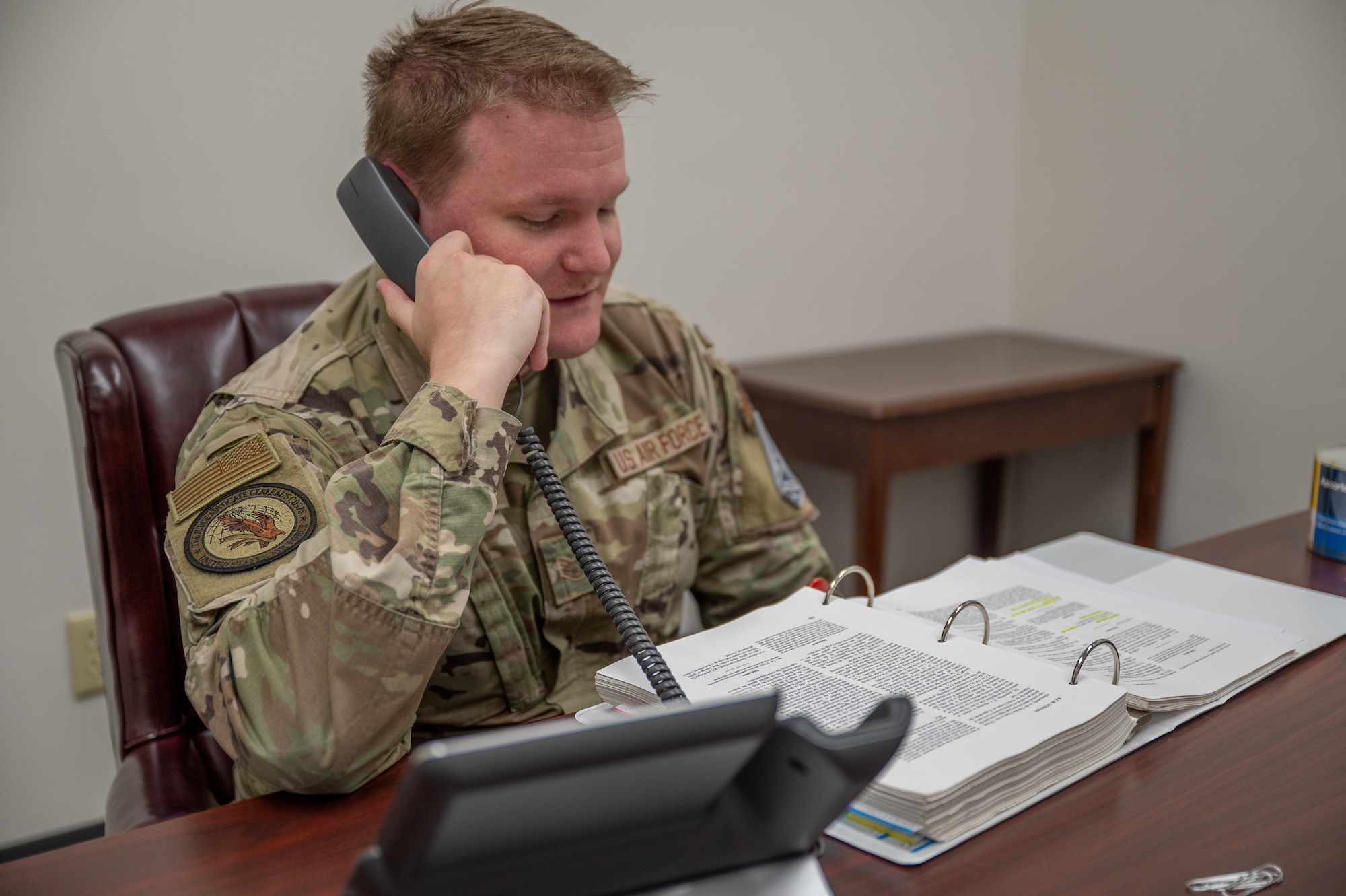 U.S. Air Force Staff Sgt. Quest Largent, Maxwell Area Defense Counsel defense paralegal, talks on the phone at Maxwell Air Force Base, Alabama, Feb. 12, 2026. By providing confidential legal counsel, the Area Defense Counsel helps Airmen navigate complex situations while maintaining focus on their duties, supporting overall readiness across the wing. (U.S. Air Force photo by Senior Airman Mikayla Cardona)