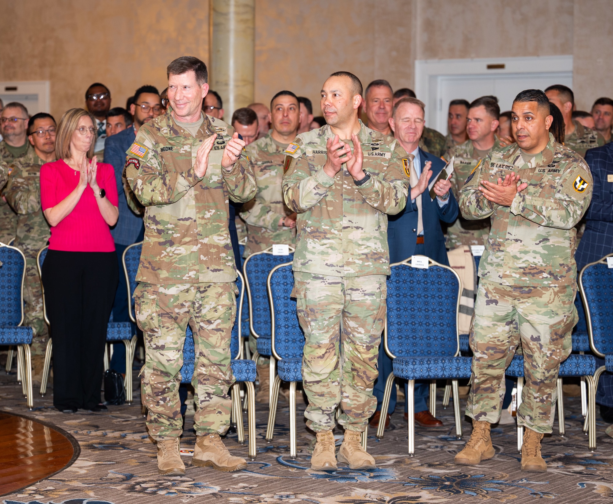 Three men in a ceremony room clap