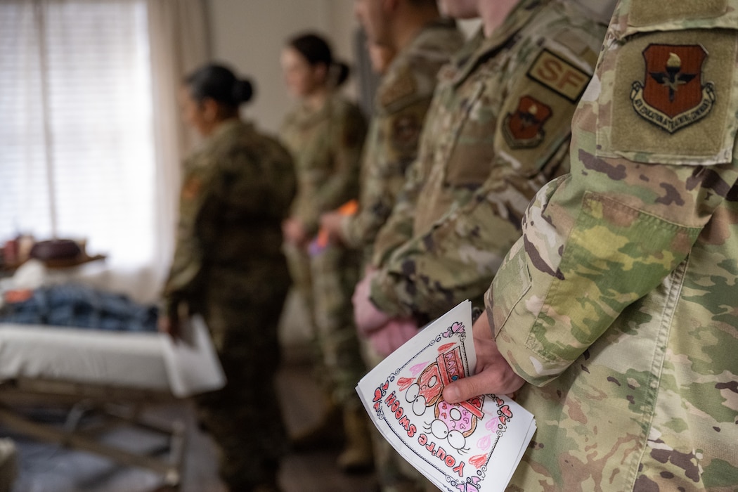 A resident of The Courtyards at Magnolia receives a valentine’s day card from a U.S. Air Force Airman in Altus, Oklahoma, Feb. 10, 2026. The card was part of a volunteer outreach effort to share appreciation with local residents and veterans and strengthen community connections. (U.S. Air Force photo by Airman 1st Class Nathan Langston)