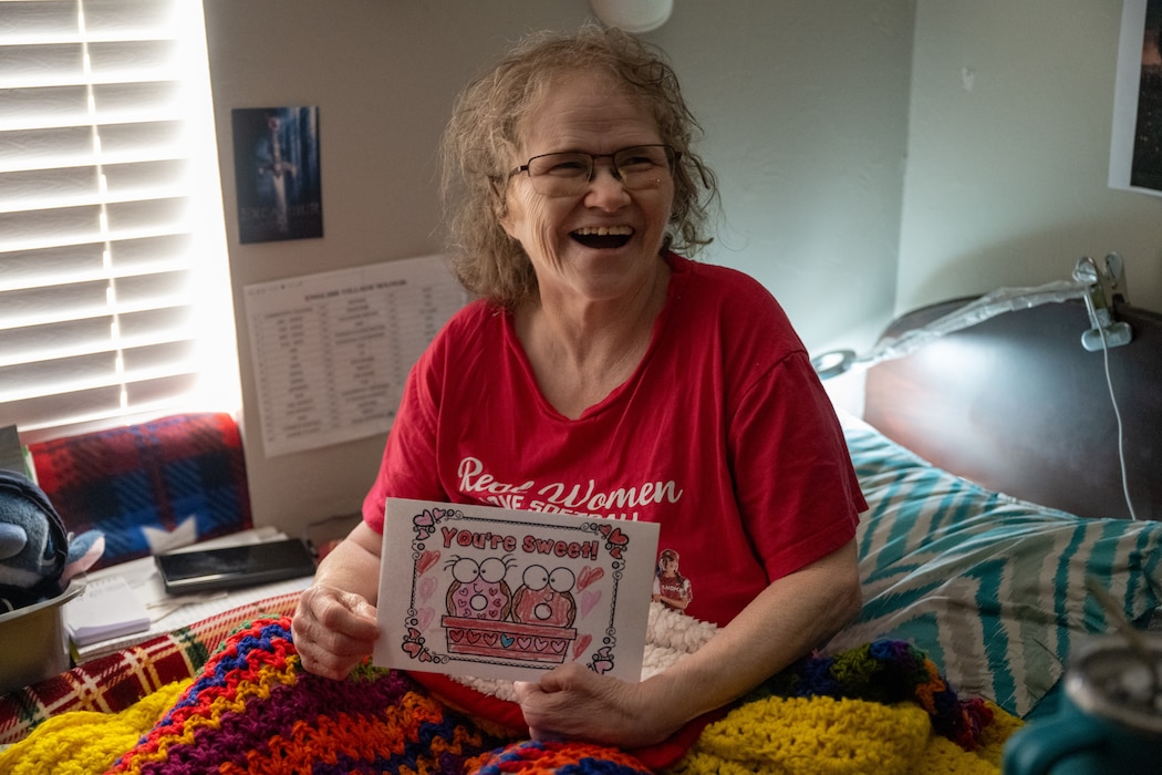 U.S. Army Veteran Shirley smiles with a valentine’s day card at English Village Manor in Altus, Oklahoma, Feb. 10, 2026. Airmen had the opportunity to listen to veteran’s experiences of their time in service, connecting the Armed Forces of the past to current Airmen. (U.S. Air Force photo by Airman 1st Class Nathan Langston)