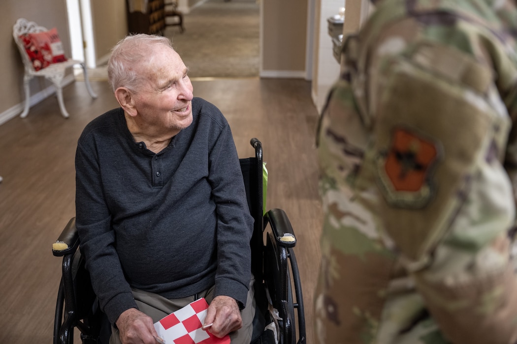 A resident of The Courtyards at Magnolia receives a valentine’s day card from a U.S. Air Force Airman in Altus, Oklahoma, Feb. 10, 2026. The card was part of a volunteer outreach effort to share appreciation with local residents and veterans and strengthen community connections. (U.S. Air Force photo by Airman 1st Class Nathan Langston)