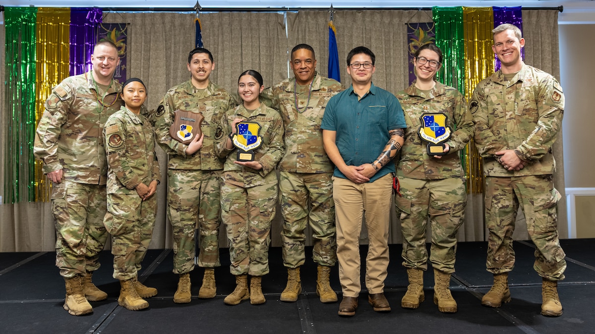 Group stand on stage to present.