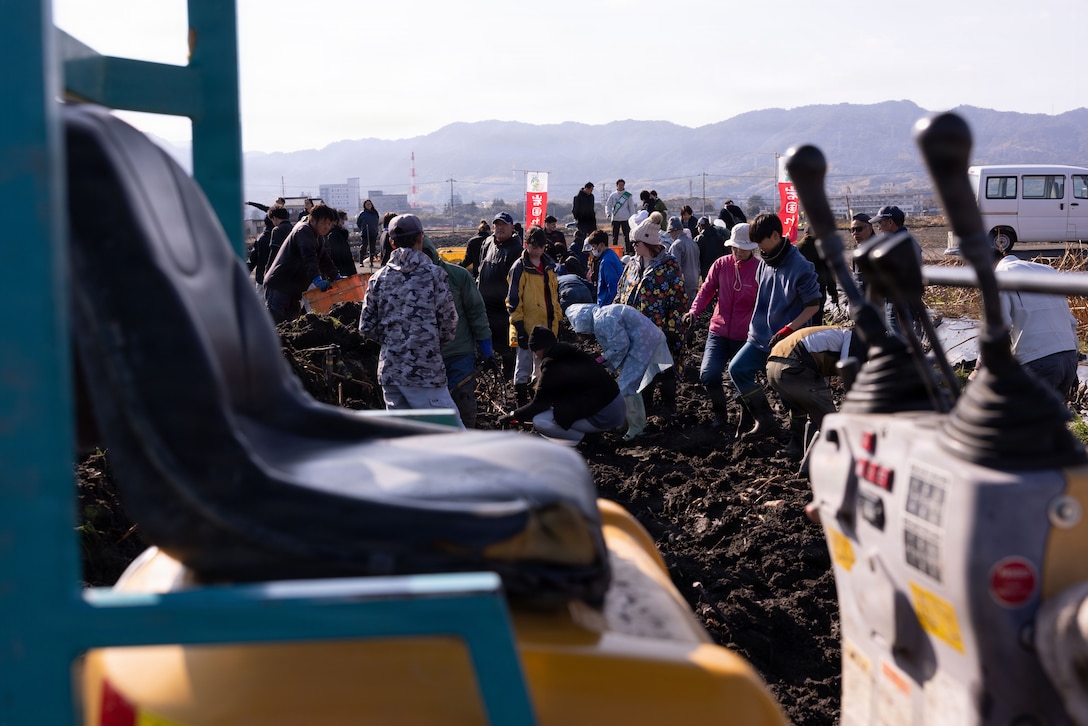 Marine Corps Air Station Iwakuni residents and local community members dig for lotus roots in Iwakuni City, Japan, Feb. 3, 2026. MCAS Iwakuni residents took part in a dig for lotus roots through the Cultural Adaptation Program with Marine Corps Community Services, as its mission is to provide base residents with opportunities to experience Japanese culture and foster relations with the local community. (U.S. Marine Corps photo by Lance Cpl. Ella Cadby)