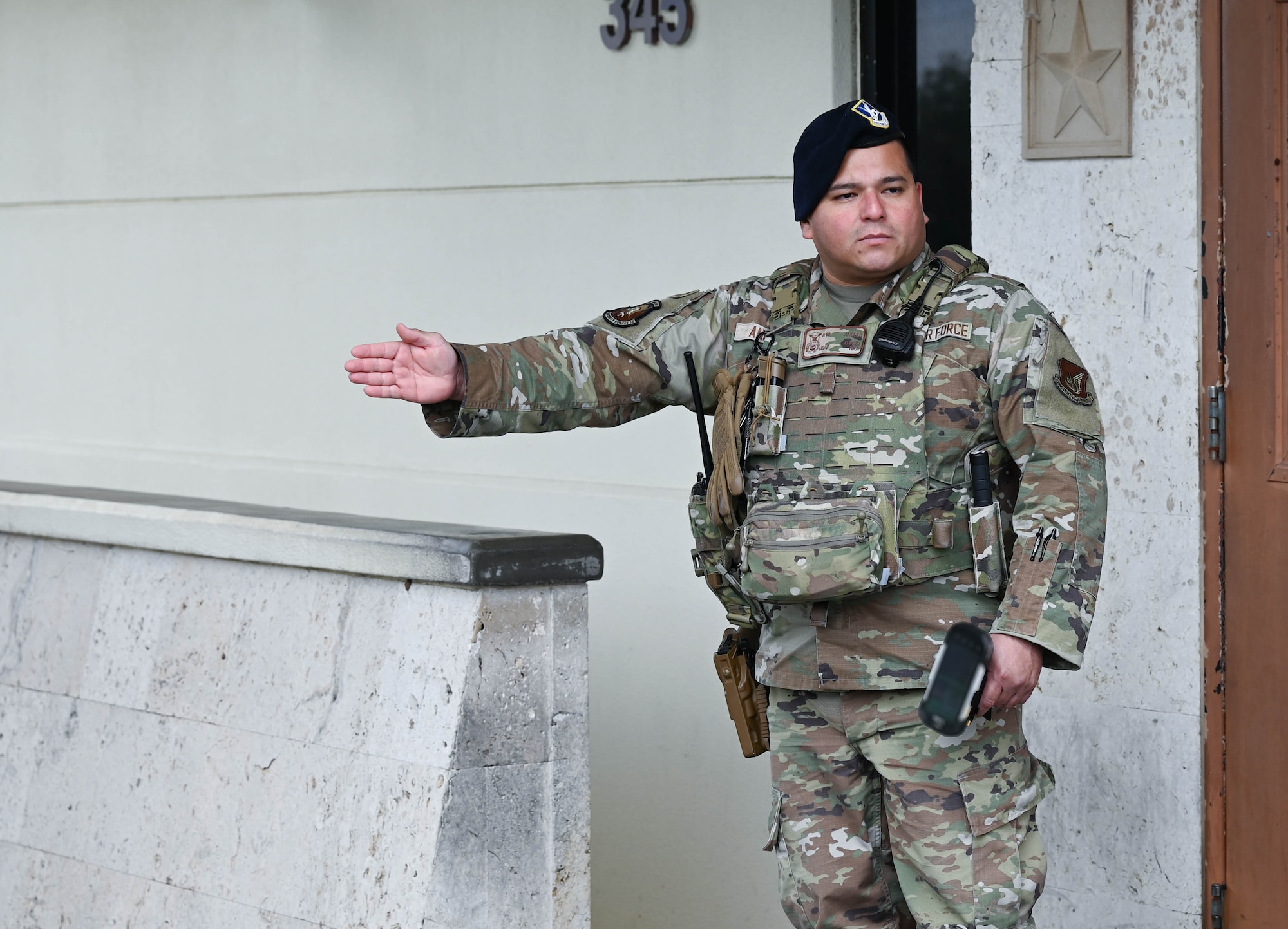 U.S. Air Force Airman 1st Class William Angulo, 18th Security Forces Squadron response force member, signals a vehicle forward for identification at Kadena Air Base, Japan, Jan. 8, 2026. The 18th SFS safeguards the installation by verifying identities, inspecting vehicles and monitoring access points to defend Kadena Air Base. (U.S. Air Force photo by Airman 1st Class Amy Kelley)