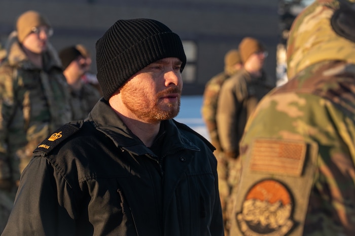 Royal Canadian Navy Petty Officer 1st Class Jeremiah Young, a Noncommissioned Officer Academy student, stands in formation during a retreat ceremony at the Elmendorf Professional Military Education Center on Joint Base Elmendorf-Richardson, Alaska, Jan. 21, 2026. The academy serves as the second tier of enlisted professional military education, designed to cultivate the leadership skills of noncommissioned officers as they prepare for the next stage of their careers. (U.S. Air Force photo by Airman 1st Class Theodore Gowdy)