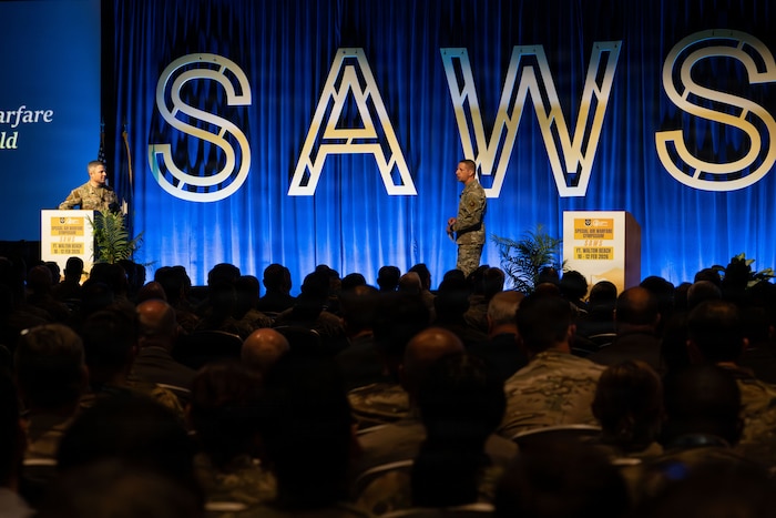 U.S. Air Force Lt. Gen. Mike Conley, left, Air Force Special Operations Command commander, and Chief Master Sgt. Courtney Freeman, right, AFSOC command chief, deliver the opening keynote during the annual Special Air Warfare Symposium and Expo (SAWS) in Fort Walton Beach, Florida, Feb. 11, 2026