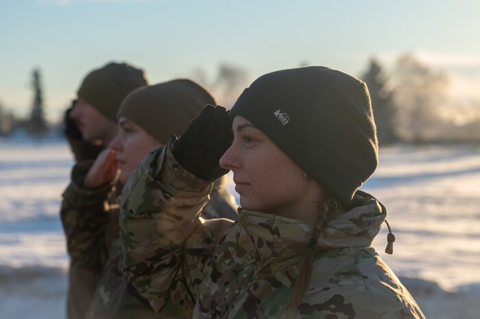Royal Danish Air Force Master Sgt. Nanna Christiansen, front, a Noncommissioned Officer Academy student, renders a salute during a retreat ceremony at the Elmendorf Professional Military Education Center on Joint Base Elmendorf-Richardson, Alaska, Jan. 21, 2026. The Elmendorf PME Center welcomed members of the Canadian and Danish armed forces to be part of NCOA in order to build meaningful relationships among future allied leaders. (U.S. Air Force photo by Airman 1st Class Theodore Gowdy)