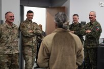 military members standing talking