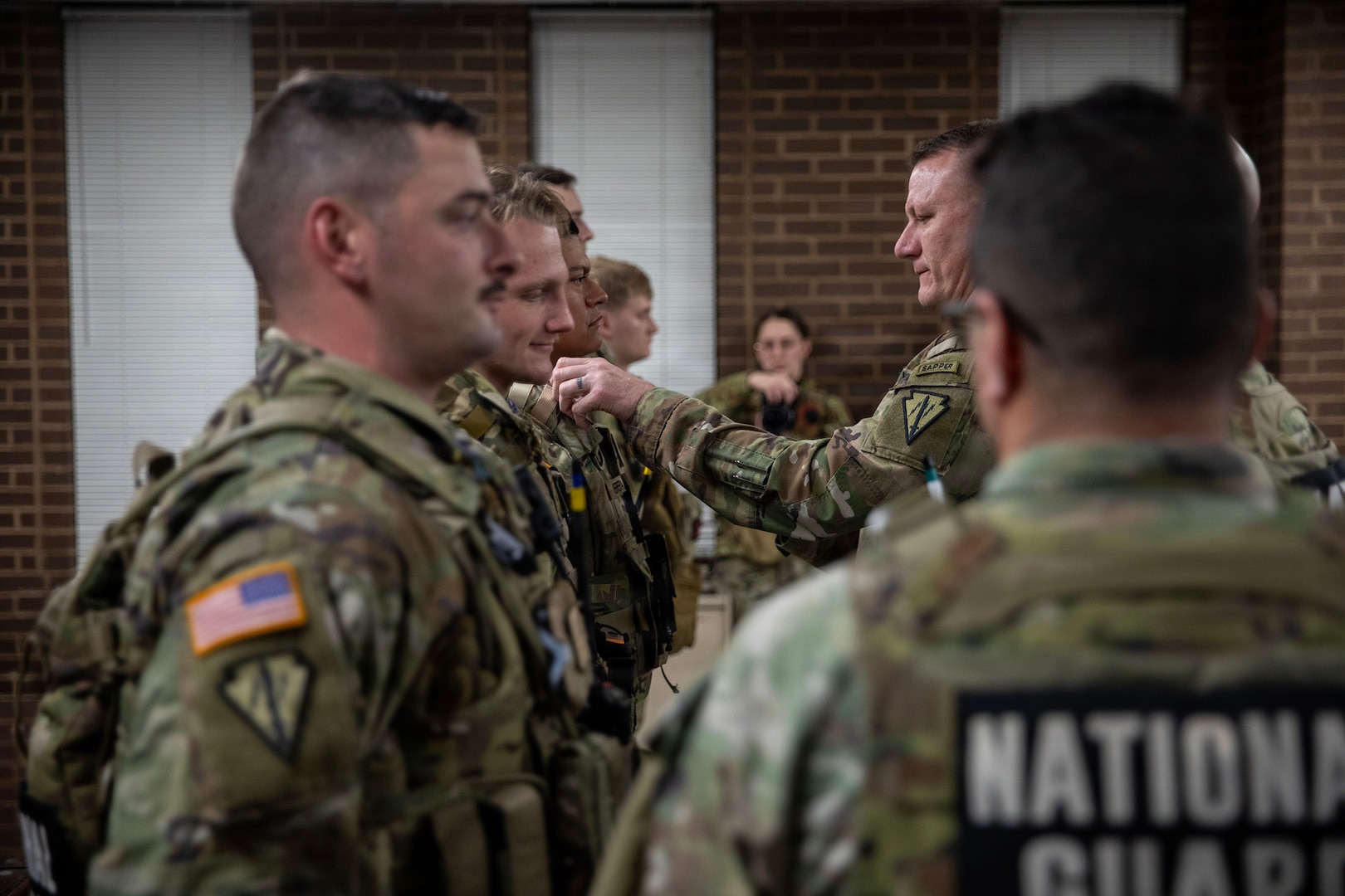 U.S. Army Lt. Col. Derek Sutton, commander of Task Force Ironman, presents Joint Service Achievement Medals to Indiana National Guard Soldiers for their actions while on patrol in Washington, Feb. 9, 2026.