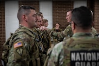 U.S. Army Lt. Col. Derek Sutton, commander of Task Force Ironman, presents Joint Service Achievement Medals to Indiana National Guard Soldiers for their actions while on patrol in Washington, Feb. 9, 2026.