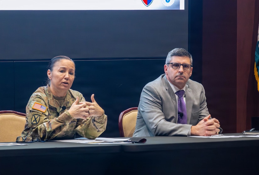 Maj. Gen. Lori Robinson, commanding general of the U.S. Army Aviation and Missile Command (AMCOM), and Don Nitti, deputy to the commanding general, discuss the workforce climate during the command's quarterly town hall in the Sparkman Center on Redstone Arsenal, Ala., on Feb. 10.
