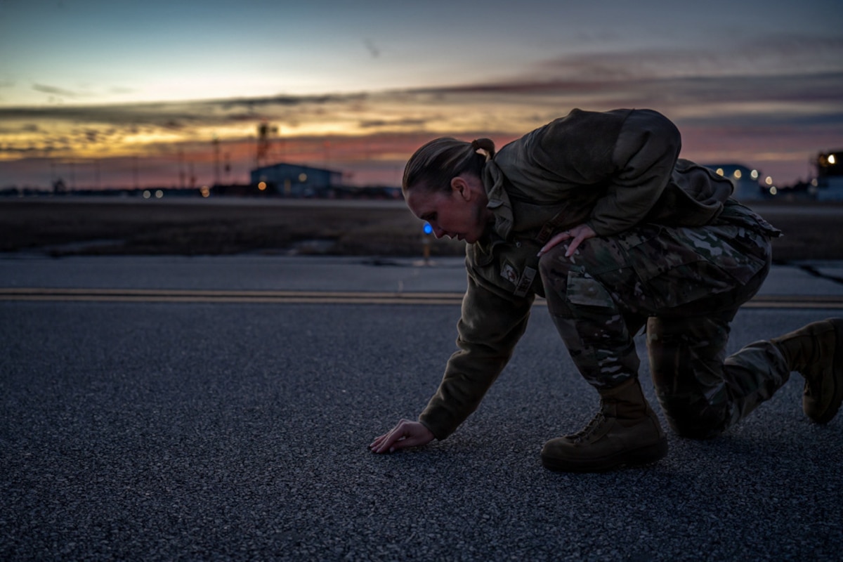 Master Sgt. Jodie Sweeney, 114th Operations Support Squadron airfield management specialist from the South Dakota Air National Guard, removes foreign object debris from the flightline during exercise Sentry South 26-1 at Savannah Air National Guard Base, Ga., Jan. 28, 2026. Sentry South is a large-scale exercise that integrates fourth- and fifth-generation aircraft and personnel from across the joint force to enhance air superiority and combat readiness. (U.S. Air National Guard photo by Staff Sgt. Taylor Solberg)