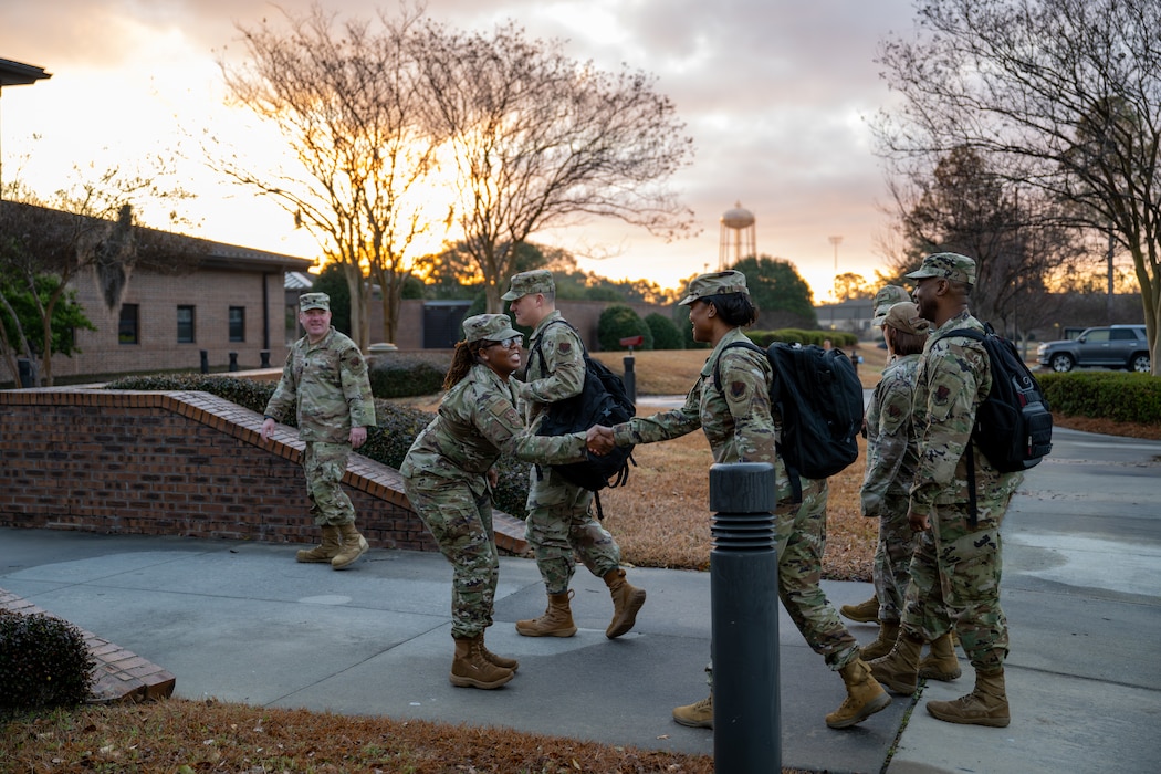 People greeting each other and shaking hands.