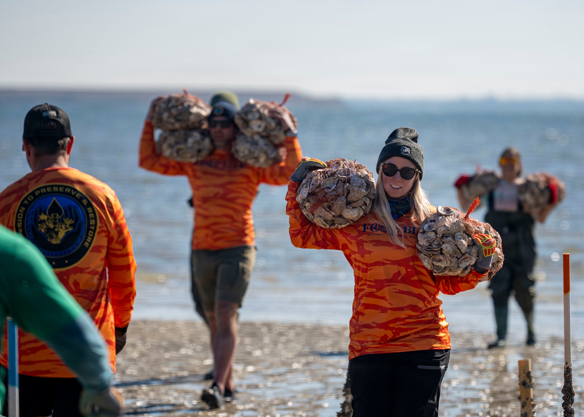 Volunteers from MacDill Air Force Base, the National Hockey League, Tampa Bay Watch, and Force Blue participate in the creation and placement of oyster shell bags during the Living Shoreline Project at MacDill Air Force Base, Florida, Jan. 29, 2026. The effort supports Phase I of the Living Shoreline Supplemental Project, a modification to the original shoreline restoration established in 2003. The oyster shells were donated by local restaurants through the Shells for Shorelines program. This partnership reinforces coastal resilience while offering base personnel opportunities to support efforts that directly impact mission readiness. The living shoreline also serves as a space for recreation and environmental education, benefiting both the installation and the surrounding community. (U.S. Air Force photo by Airman 1st Class Monique Stober)