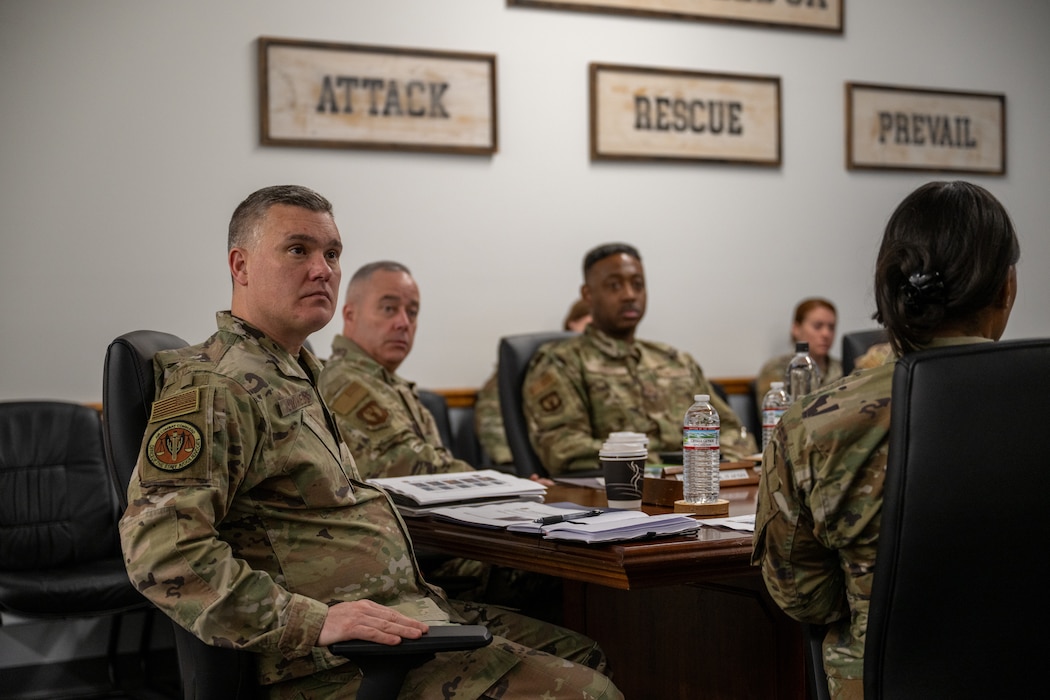 Man sitting and listening to someone talking.