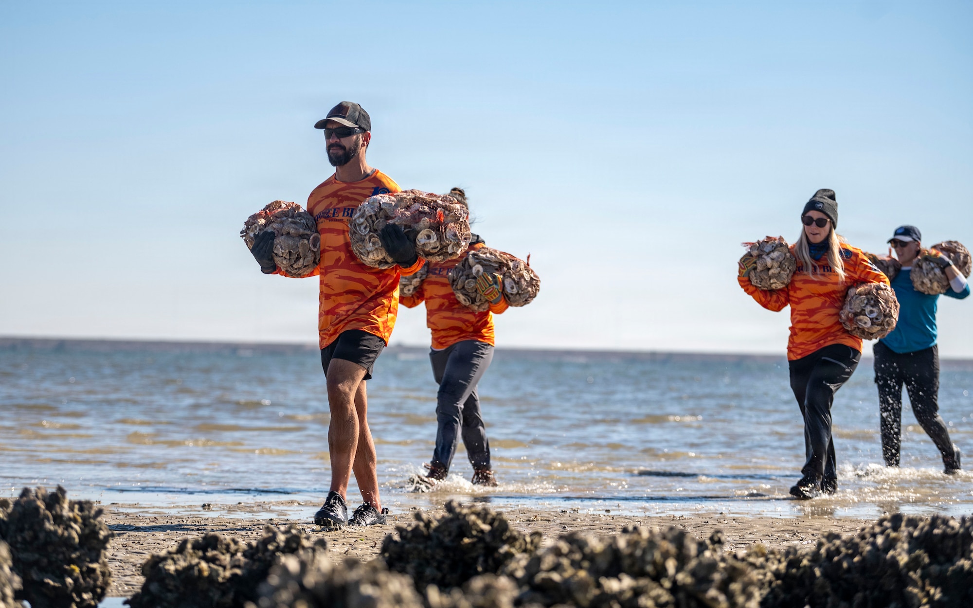 Volunteers from MacDill Air Force Base, the National Hockey League, Tampa Bay Watch, and Force Blue participate in the creation and placement of oyster shell bags during the Living Shoreline Project at MacDill Air Force Base, Florida, Jan. 29, 2026. The effort supports Phase I of the Living Shoreline Supplemental Project, a modification to the original shoreline restoration established in 2003. The oyster shells were donated by local restaurants through the Shells for Shorelines program. This partnership reinforces coastal resilience while offering base personnel opportunities to support efforts that directly impact mission readiness. The living shoreline also serves as a space for recreation and environmental education, benefiting both the installation and the surrounding community. (U.S. Air Force photo by Airman 1st Class Monique Stober)