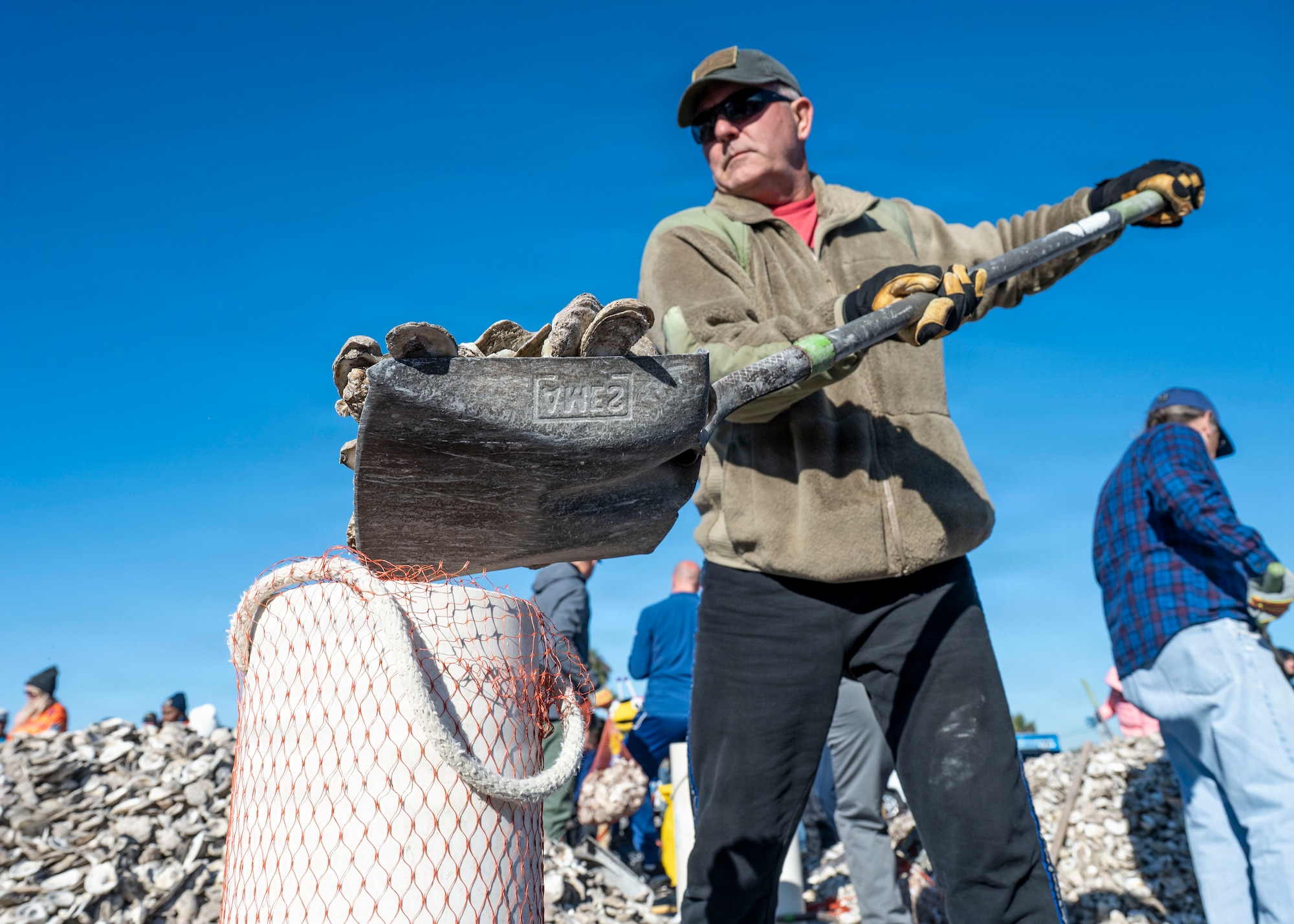 Volunteers from MacDill Air Force Base, the National Hockey League, Tampa Bay Watch, and Force Blue participate in the creation and placement of oyster shell bags during the Living Shoreline Project at MacDill Air Force Base, Florida, Jan. 29, 2026. The effort supports Phase I of the Living Shoreline Supplemental Project, a modification to the original shoreline restoration established in 2003. The oyster shells were donated by local restaurants through the Shells for Shorelines program. This partnership reinforces coastal resilience while offering base personnel opportunities to support efforts that directly impact mission readiness. The living shoreline also serves as a space for recreation and environmental education, benefiting both the installation and the surrounding community. (U.S. Air Force photo by Airman 1st Class Monique Stober)