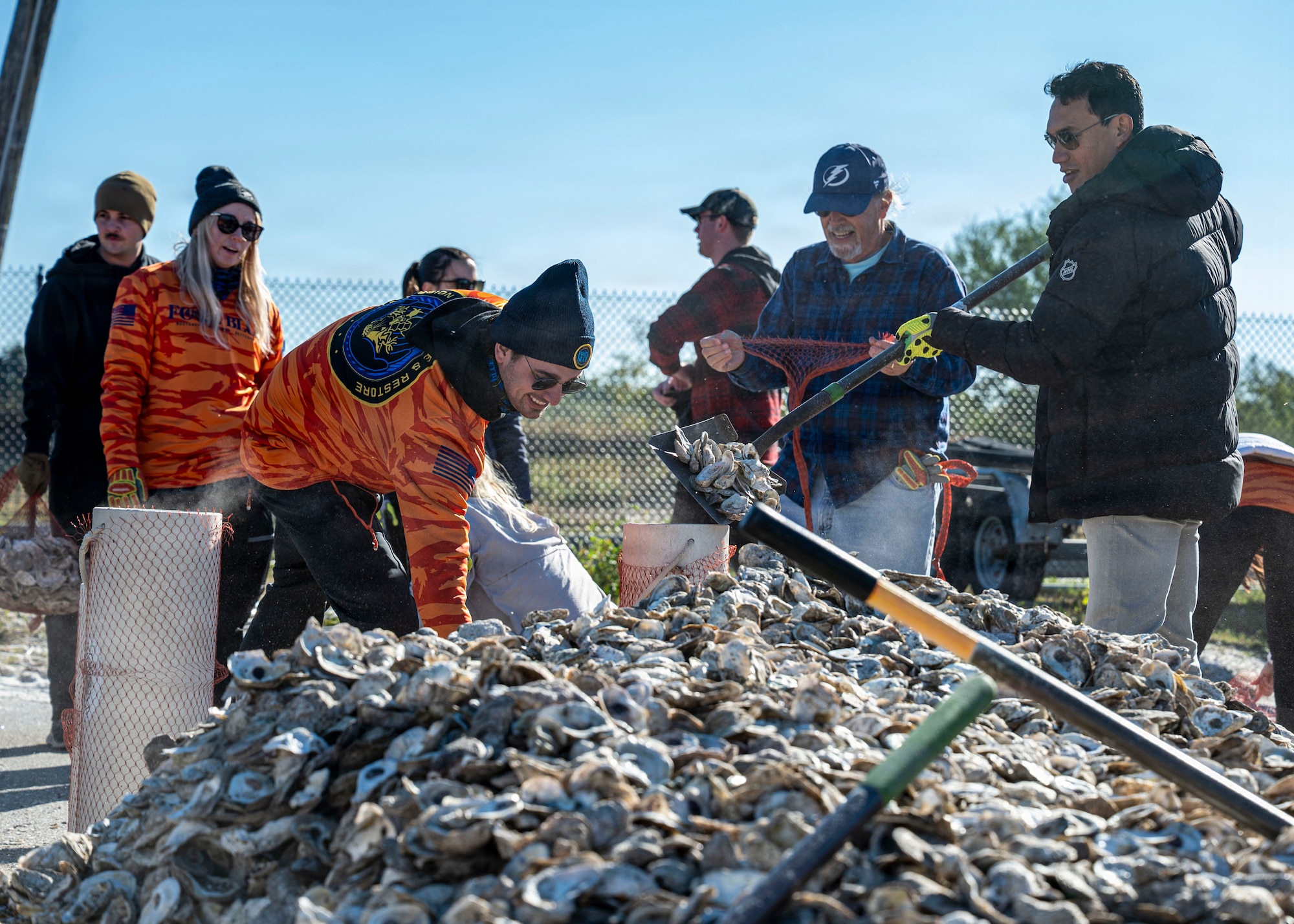 Volunteers from MacDill Air Force Base, the National Hockey League, Tampa Bay Watch, and Force Blue participate in the creation and placement of oyster shell bags during the Living Shoreline Project at MacDill Air Force Base, Florida, Jan. 29, 2026. The effort supports Phase I of the Living Shoreline Supplemental Project, a modification to the original shoreline restoration established in 2003. The oyster shells were donated by local restaurants through the Shells for Shorelines program. This partnership reinforces coastal resilience while offering base personnel opportunities to support efforts that directly impact mission readiness. The living shoreline also serves as a space for recreation and environmental education, benefiting both the installation and the surrounding community. (U.S. Air Force photo by Airman 1st Class Monique Stober)