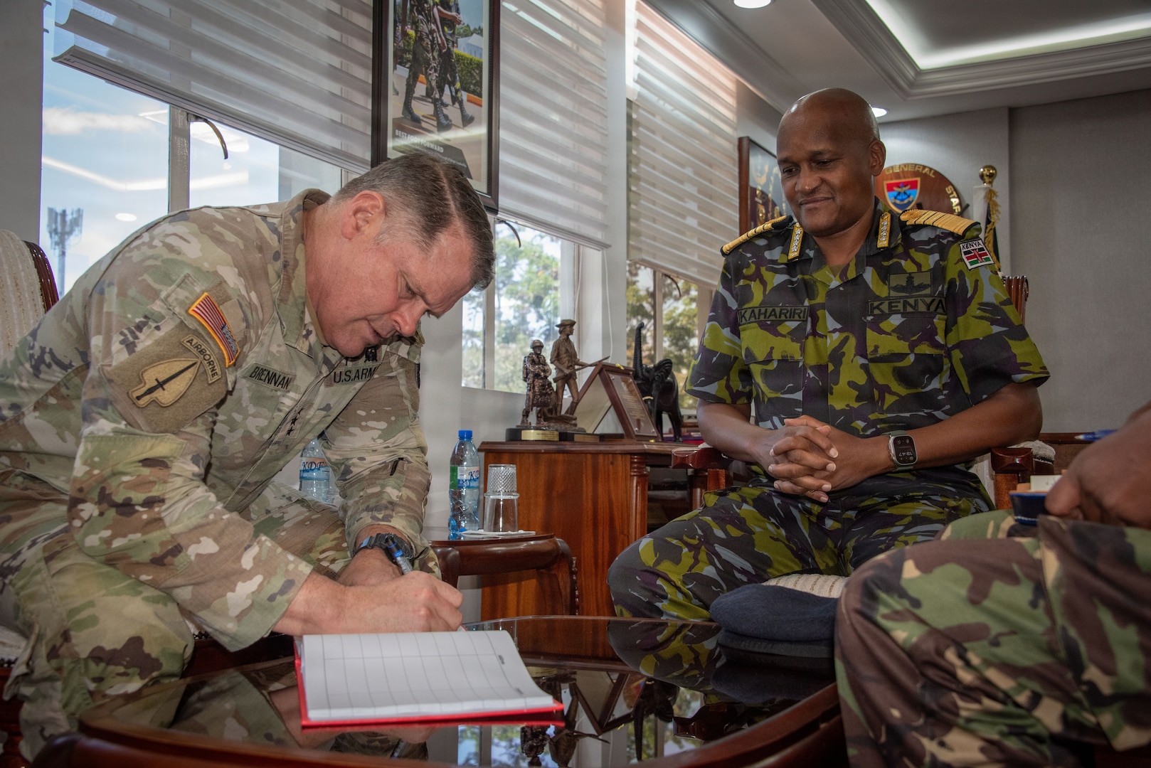 U.S. Army Lt. Gen. John Brennan, U.S. Africa Command, deputy commander, signs Kenyan Gen. Charles Muriu Kahariri’s, Kenya Chief of Defence Forces, welcome book during a meeting at the CHOD’s office in Nairobi, Kenya, Feb. 5, 2026.