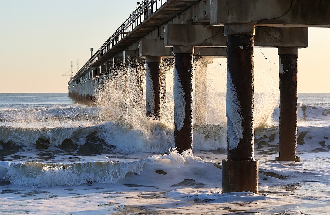Frigid temperatures and blizzard-like conditions accompanied the high winds and heavy surf of a late January nor'easter in Duck, North Carolina. The sea spray and below-freezing air created a coating of ice on the support structure of the Field Research Facility’s pier. (Photo by Erin Diurba)