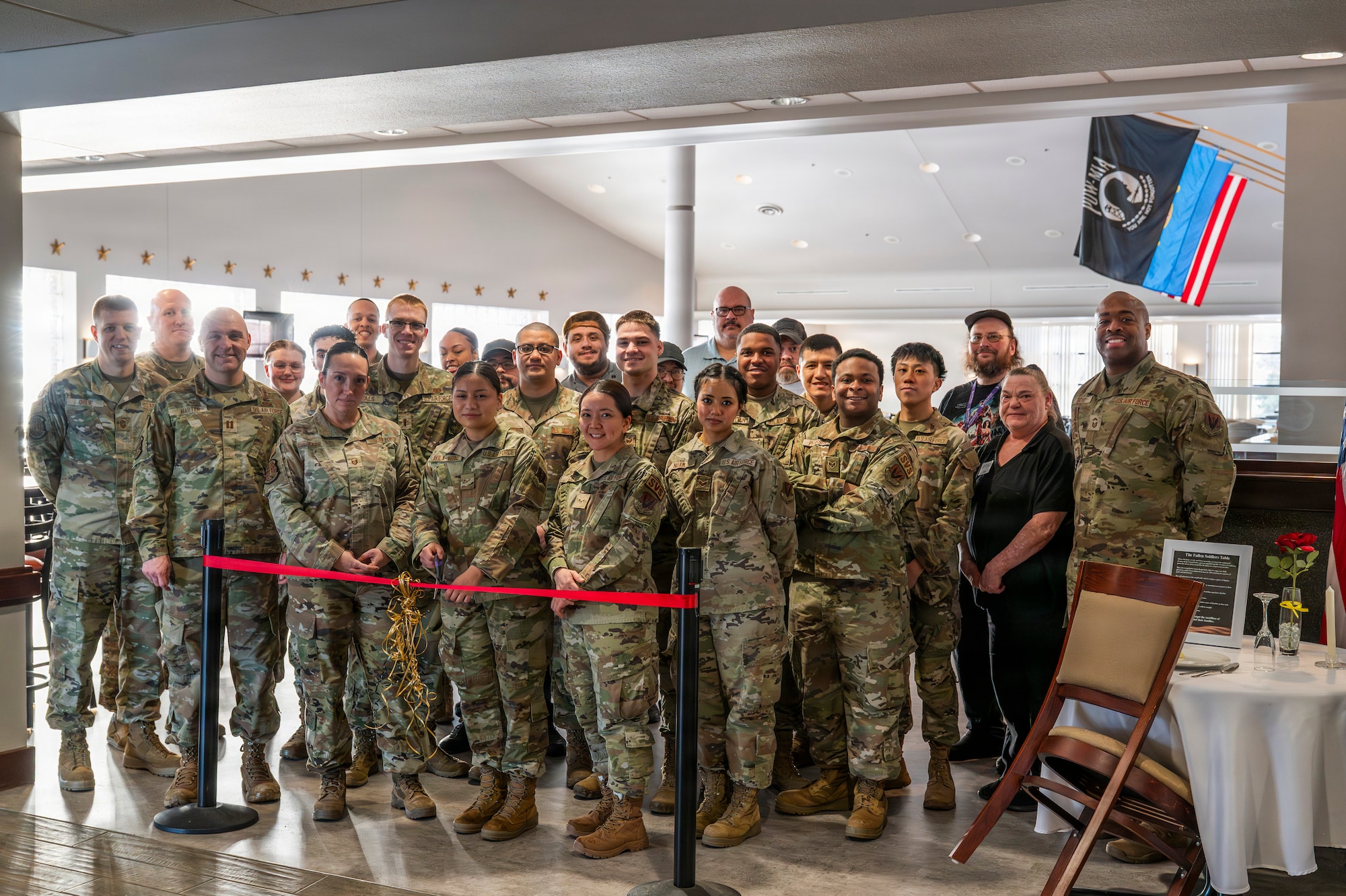 319th Force Support Squadron members prepare to cut the ribbon, officially reopening the renovated Airey Dining Facility dining room at Grand Forks Air Force Base, North Dakota, Feb. 9, 2026.