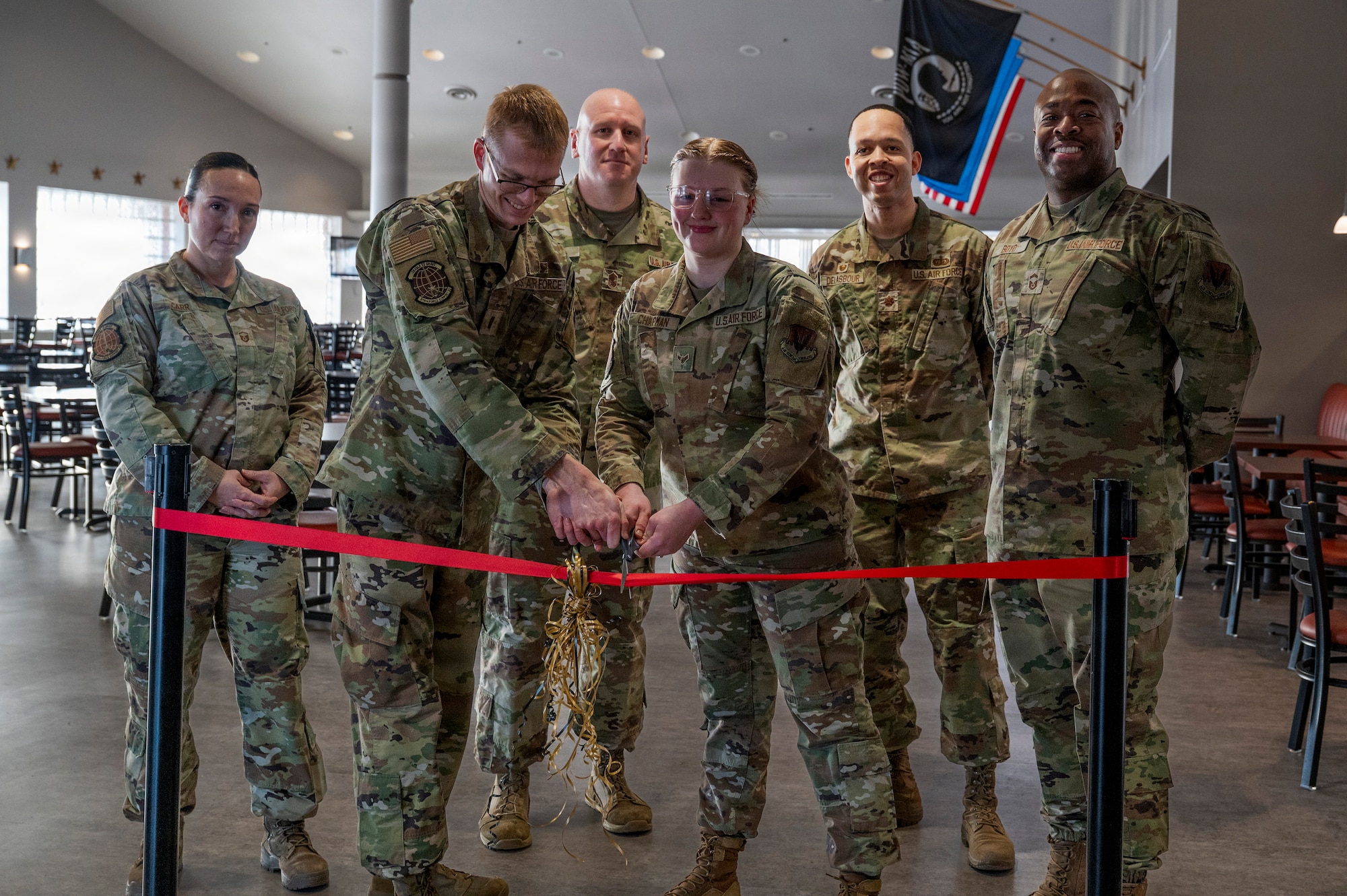 319th Force Support Squadron members cut the ribbon, officially opening the newly renovated Airey Dining Facility dining room at Grand Forks Air Force Base, North Dakota, Feb. 9, 2026.