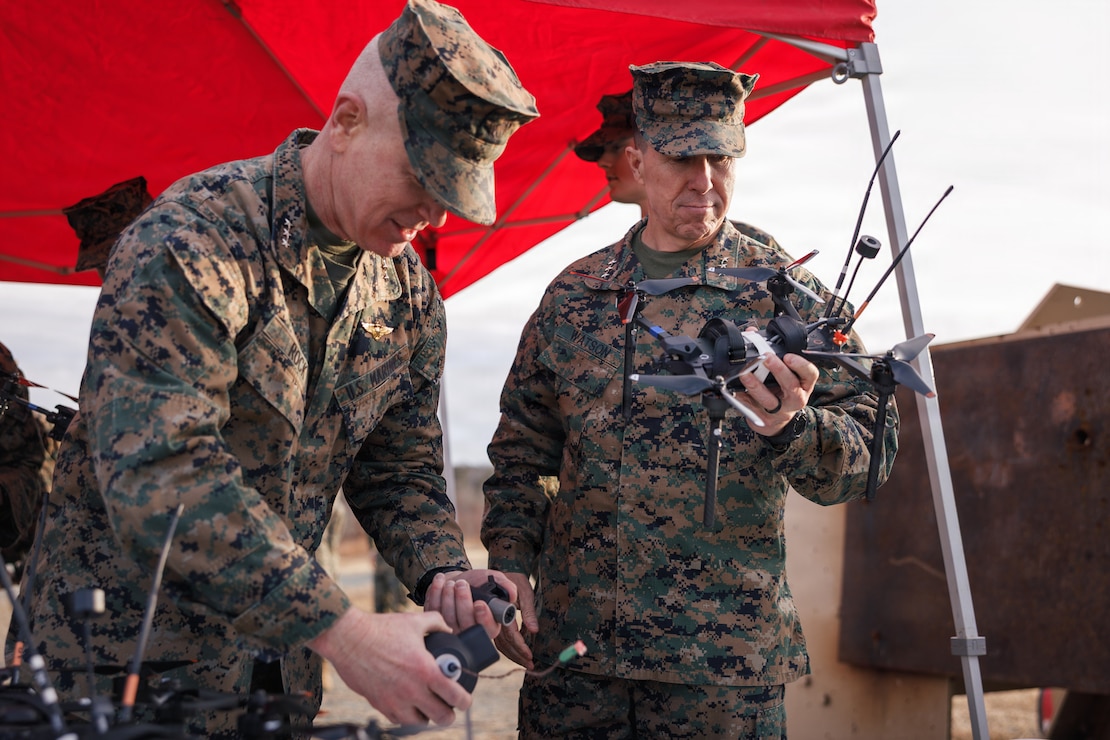 U.S. Marine Corps Lt. Gen. Paul J. Rock Jr., director, Marine Corps Staff, Headquarters Marine Corps, left, and Lt. Gen. Benjamin T. Watson, commanding general, Training and Education Command, observe a Neros Archer first-person view attack drone and associated components during a Marine Corps Attack Drone Team demonstration at Marine Corps Base Quantico, Virginia, Jan. 22, 2026. The demonstration was part of the Executive Off-Site Symposium, a quarterly two- to three-day gathering of senior leaders focused on the Corps’ most important topics and featured first-person view attack drone capabilities. (U.S. Marine Corps photo by Cpl. Joshua Barker)