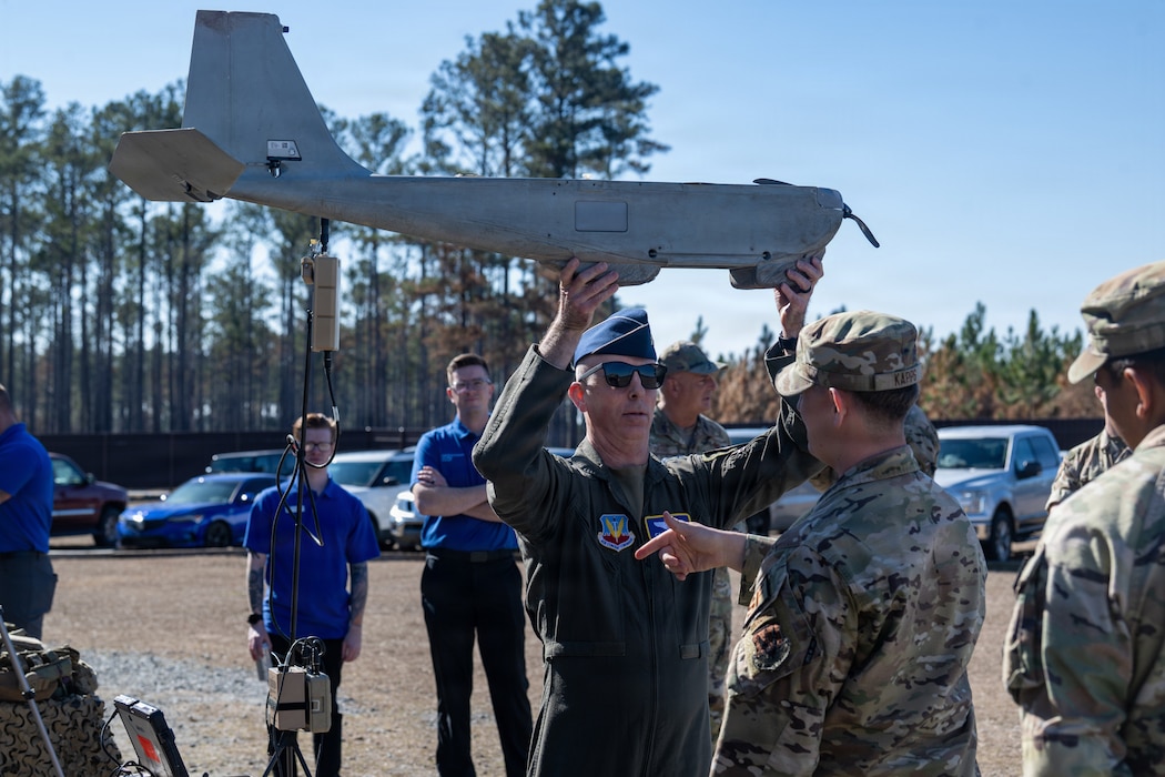 Photo of someone holding a unmanned aerial vehicle.