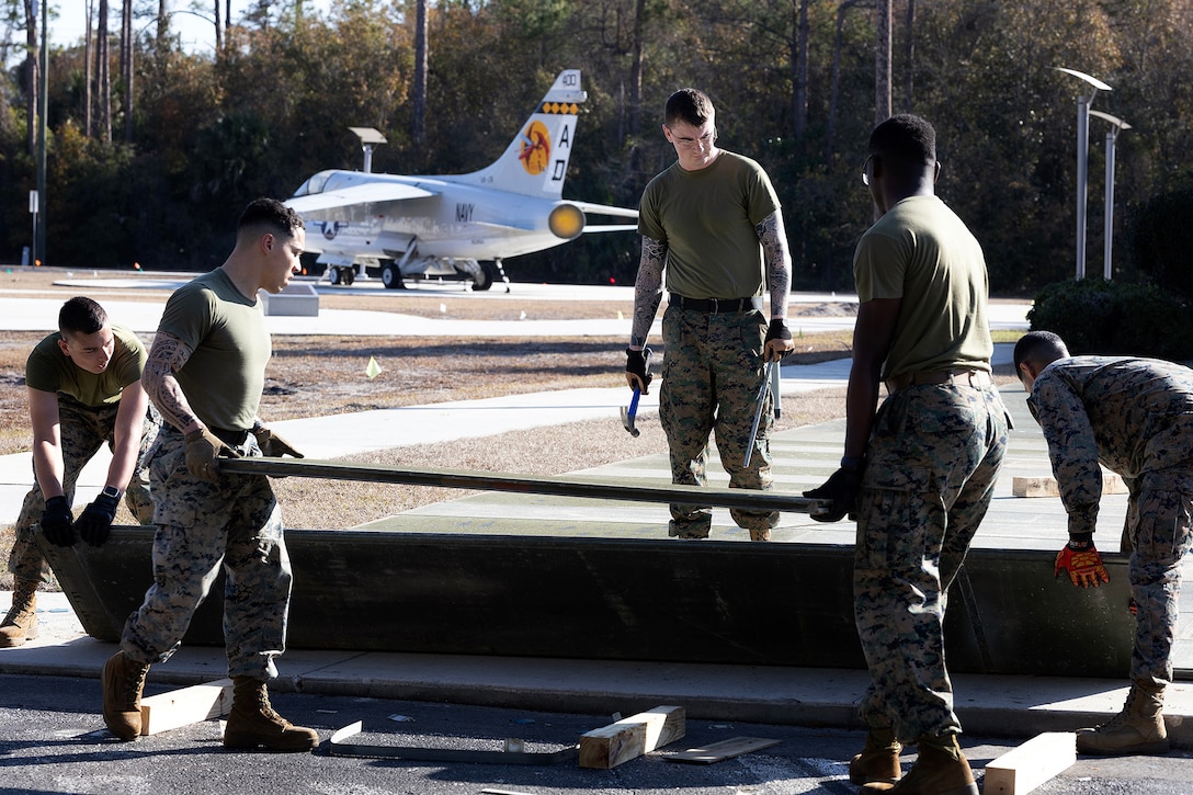 U.S. Marines assigned to Blount Island Command lay aluminum expeditionary airfield matting Feb. 12, 2026, at the National POW/MIA Memorial and Museum site in Jacksonville, Florida. The matting, which was drawn from prepositioning sets at Marine Corps Support Facility Blount Island, will support the movement of a restored S-3 Viking aircraft onto the developing Legacy Plaza at the National POW/MIA Memorial and Museum site at Cecil Field. (Official U.S. Marine Corps photo by Dustin Senger)