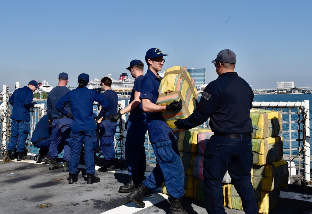 USCGC Seneca (WMEC 906) crew members load bales of illicit drugs on pallets during a drug offload at Port Everglades in Fort Lauderdale, Florida, Feb.13, 2026. The crew offloaded 17,750 pounds of illicit drugs worth more than $133 million as a result of four interdictions in the Eastern Pacific Ocean. (U.S. Coast Guard photo by Petty Officer 3rd Class Moriah Cannion)