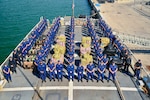 The crew of USCGC Seneca (WMEC 906) stand for a photo during a drug offload at Port Everglades in Fort Lauderdale, Florida, Feb. 30, 2025. The crew offloaded more than 17,750 pounds of illicit narcotics worth more than $133 million as a result of four interdictions in the international waters of the Eastern Pacific Ocean. (U.S. Coast Guard photo by Petty Officer 2nd Class Eric Rodriguez)