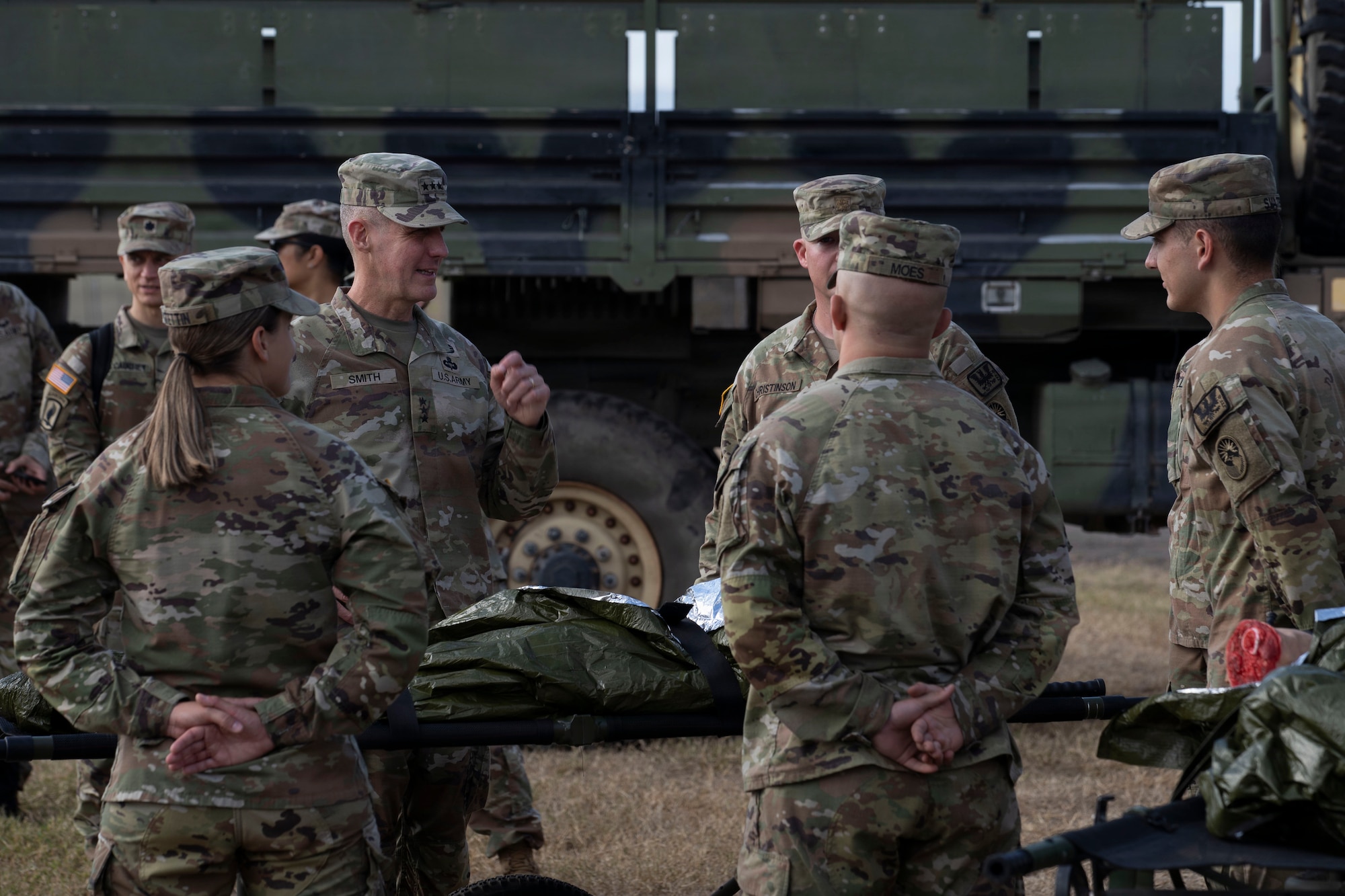 People in military uniforms talk to one another