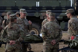 People in military uniforms talk to one another