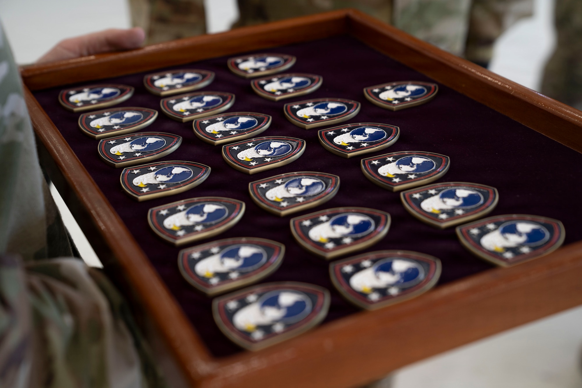 Coins rest in a wooden box