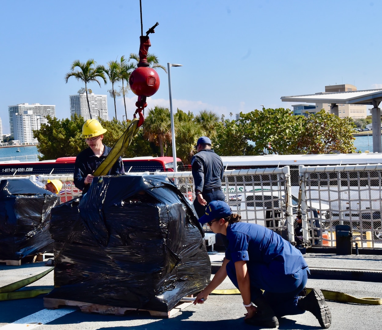 USCGC Seneca (WMEC 906) crew members secure a pallet of illicit drugs to a crane during a drug offload at Port Everglades in Fort Lauderdale, Florida, Feb.13, 2026. The crew offloaded 17,750 pounds of illicit drugs worth more than $133 million as a result of four interdictions in the Eastern Pacific Ocean. (U.S. Coast Guard photo by Petty Officer 3rd Class Moriah Cannion)