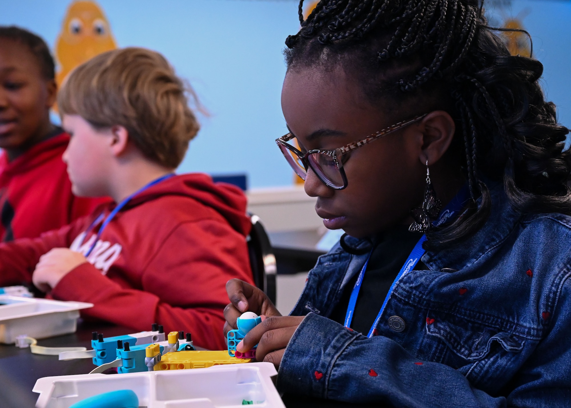 A student assembles a mechanical component during a robotics and coding lesson at Maxwell Air Force Base, Alabama, Feb. 12, 2026.