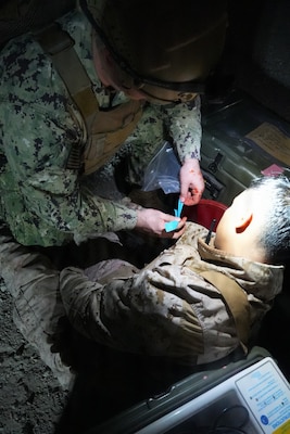 Lt. Grant Ingalls (left), a physician assistant assigned to Expeditionary Resuscitative Surgical System (ERSS) 21, Navy Reserve, provides simulated medical care to Hospital Corpsman 3rd Class Isaiah Gutierez (right), an instructor assigned to the Naval Expeditionary Medicine Warfighter Development Center (NEMWDC), during an ERSS training evolution at Camp Pendleton, California, Jan. 19-30, 2026.  The training, conducted by NEMWDC, focuses on delivering effective patient care while operating with limited resources in austere environments.  (U.S. Navy photo by Petty Officer 2nd Class Moira Esquivel)