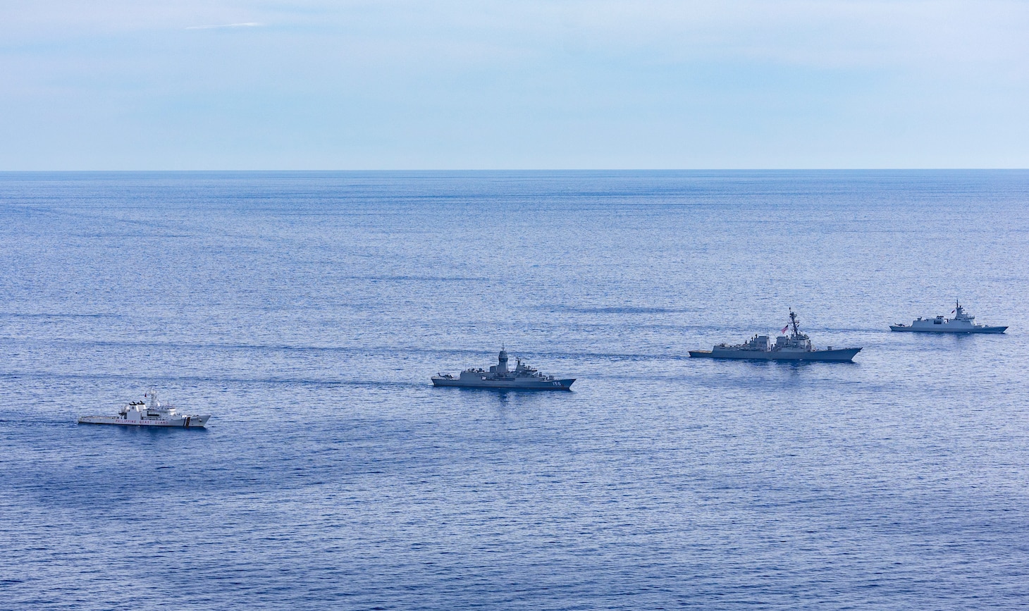 From left, Philippine Coast Guard Teresa Magbanua-class patrol vessel BRP Teresa Magbanua (MRRV 9701), Royal Australian Navy Anzac-class frigate HMAS Toowoomba (FFH 156), U.S. Navy Arleigh Burke-class guided-missile destroyer USS Dewey (DDG 105) and Philippine Navy Jose Miguel Malvar-class guided-missile frigate BRP Diego Silang (FFG 07) sail in formation during the Maritime Cooperative Activity (MCA) in the Philippines' Exclusive Economic Zone, Feb. 16, 2026. The U.S. Navy routinely operates with the Armed Forces of the Philippines and partners and allies through MCAs to continually develop, exercise and enhance multi-domain tactical interoperability to uphold peace and security in the region. Dewey is forward-deployed and assigned to Destroyer Squadron (DESRON) 15, the Navy’s largest DESRON and the U.S. 7th Fleet’s principal surface force. (U.S. Navy photo by Mass Communication Specialist 2nd Class Oscar Diaz)
