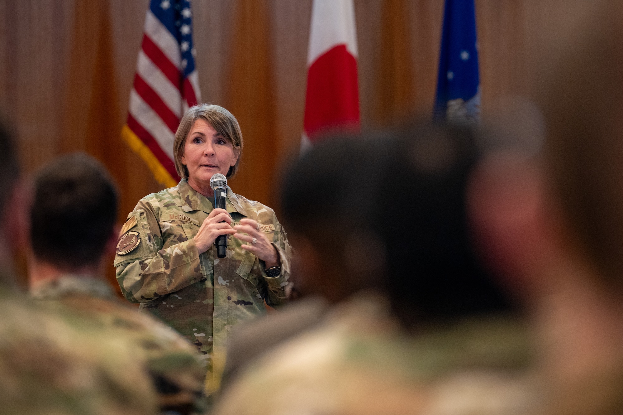 Chief Master Sgt. Katie McCool, Pacific Air Forces command chief, addresses Airmen during an Enlisted All Call at Kadena Air Base, Japan