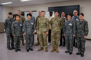U.S. Air Force Airmen and Japan Air Self-Defense Force members pose for a photo.