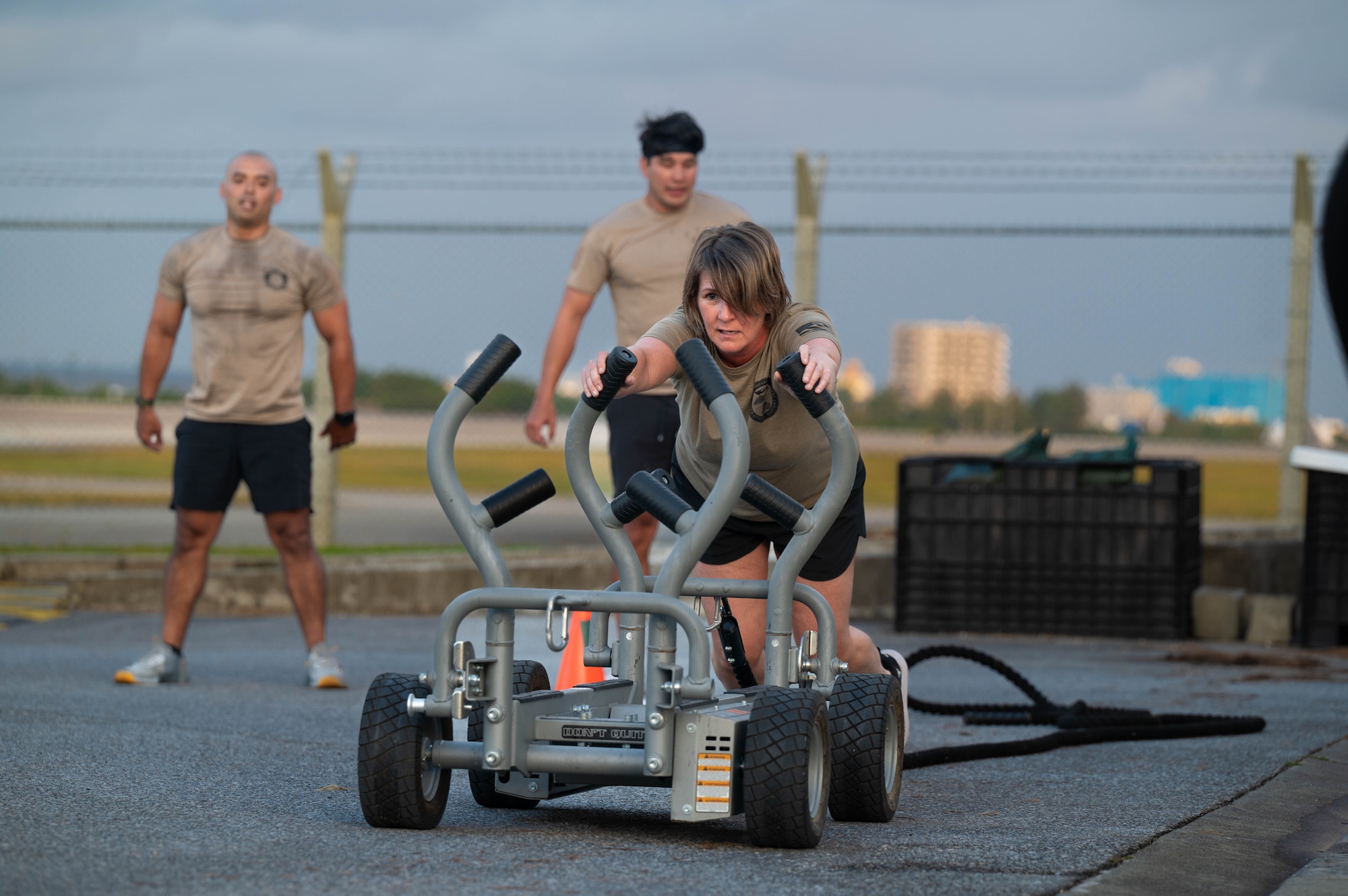 Chief Master Sgt. Katie McCool, Pacific Air Forces command chief, pushes a weighted cart for physical training.