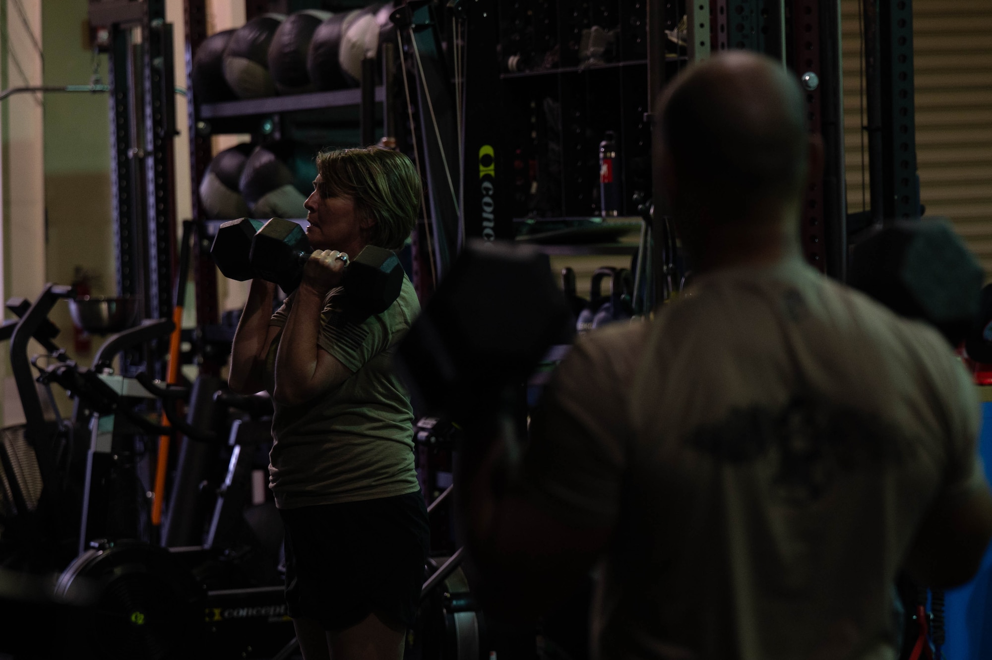 Chief Master Sgt. Katie McCool, Pacific Air Forces command chief, lifts weights for physical training