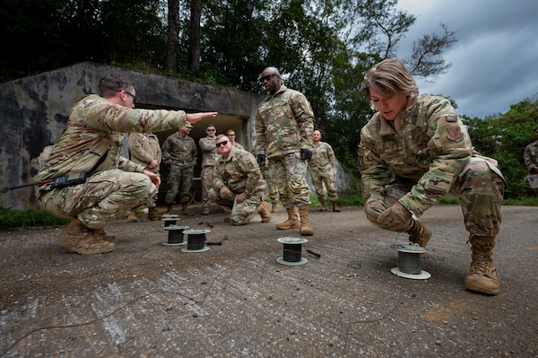 Chief Master Sgt. Kathleen McCool, Pacific Air Forces command chief participates in an EOD demonstration
