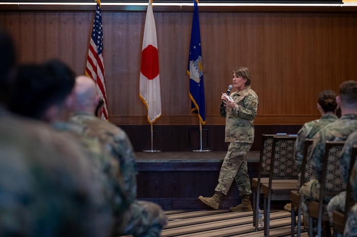 Chief Master Sgt. Katie McCool, Pacific Air Forces command chief, addresses Airmen during an Enlisted All Call at Kadena Air Base