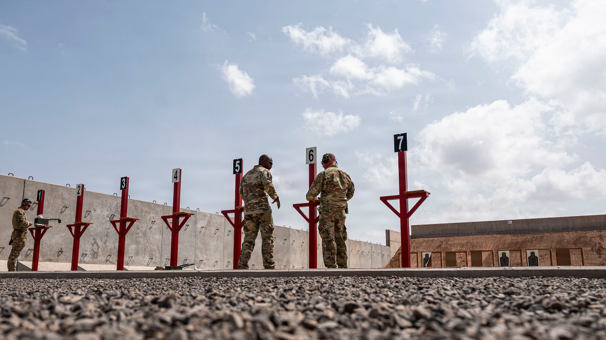 U.S. Air Force Airmen assigned to the 776th Expeditionary Air Base Squadron prepare to fire handguns at the newly opened on-site small arms range at Chabelley Airfield