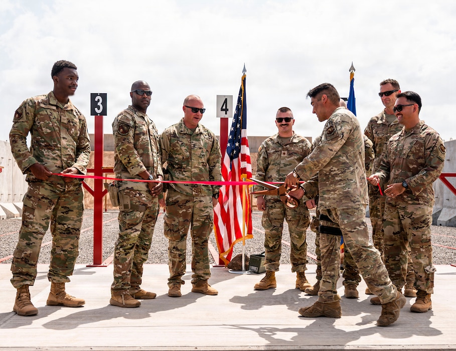 U.S. Air Force Airmen assigned to the 776th Expeditionary Air Base Squadron participate in a ribbon cutting ceremony marking the opening of the first on-site small arms range  at Chabelley Airfield, Djibouti