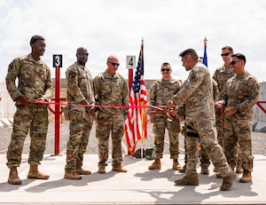 U.S. Air Force Airmen assigned to the 776th Expeditionary Air Base Squadron participate in a ribbon cutting ceremony marking the opening of the first on-site small arms range  at Chabelley Airfield, Djibouti