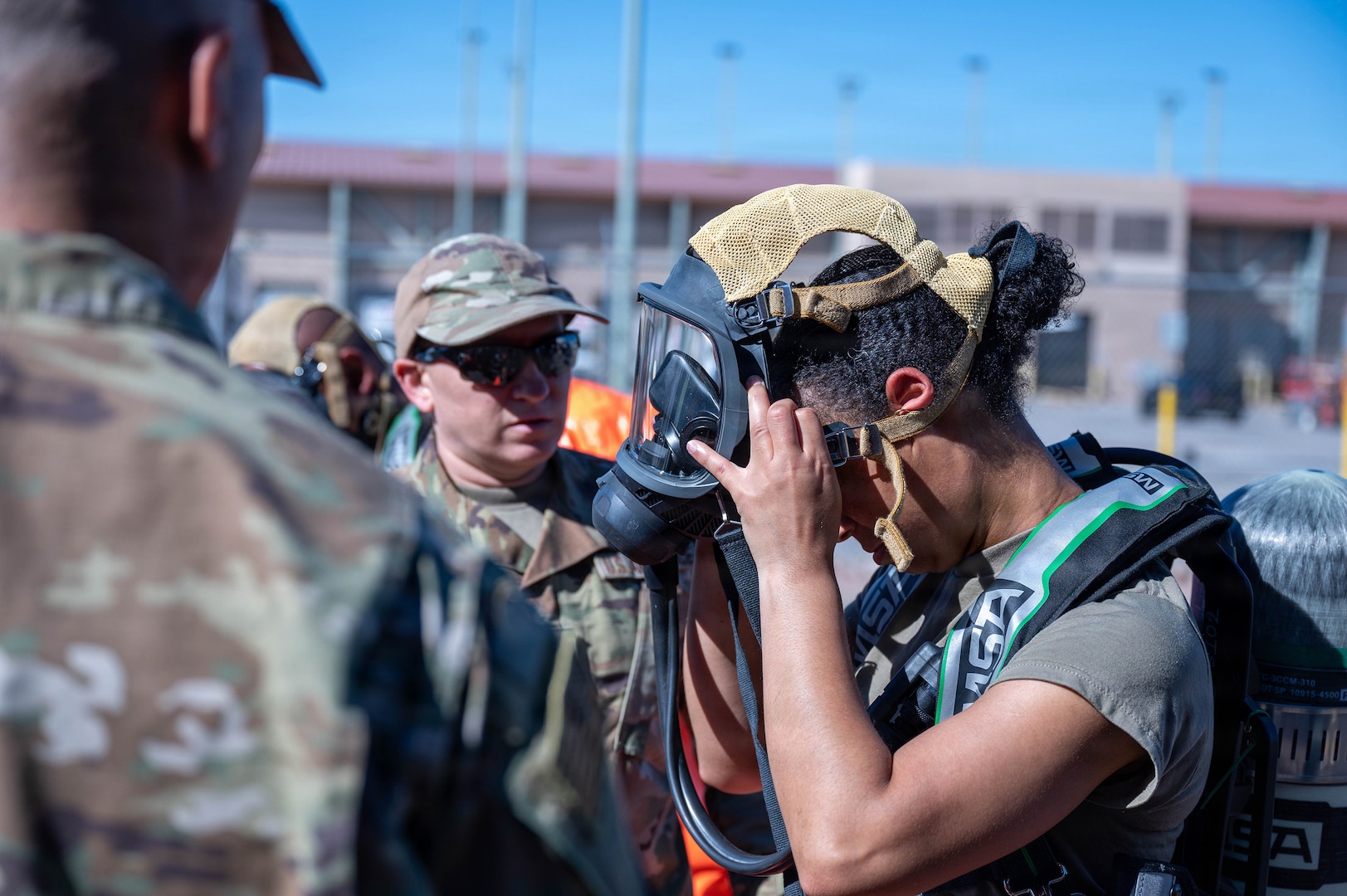 U.S. Air Force Reserve Staff Sgt. Sara Weaver, 944th Civil Engineering Squadron Emergency Management, assists U.S. Air Force Airman Jimi Richardson, 56th Fighter Wing Emergency Management, for a chemical, biological, radiological, nuclear, or explosives (CBRNE) field training exercise at Goldwater Air National Guard base, Phoenix, Feb. 14, 2026.